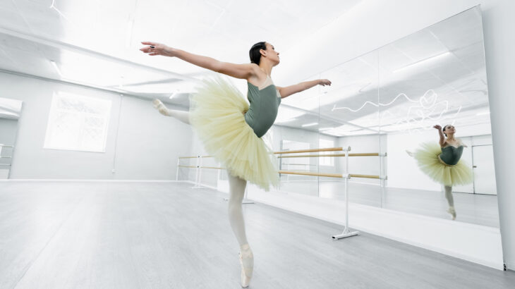 full length view of graceful ballerina dancing during repetition
